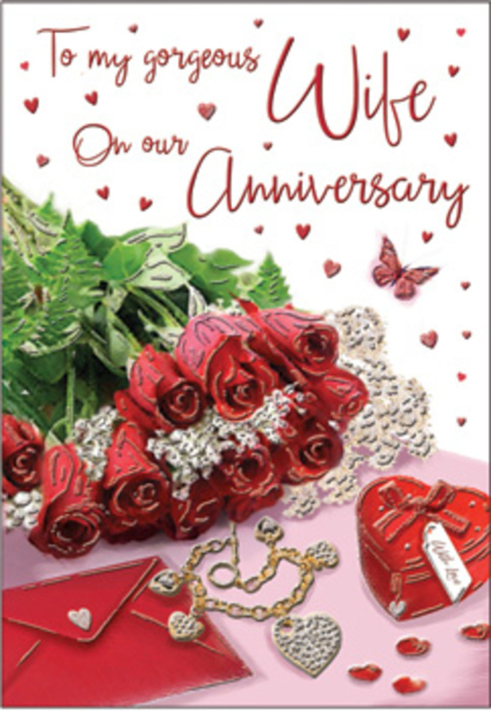 In this richly detailed anniversary card design, a classic bouquet of red roses becomes the emotional anchor of a romantic still life that could easily have been inspired by a cosy home in Tring. The roses are full and luxurious, with tightly layered petals arranged in perfect spirals, each bloom at its peak, their deep crimson shade radiating warmth against the pale background. They are bound with subtle wrapping and complemented by lush green foliage that fans out gently, bringing a sense of natural abundance, like a hand-tied bouquet collected from a trusted florist just off Tring High Street. Surrounding the flowers are tender symbols of long-lasting love: a polished heart-shaped box in vivid red, its surface gleaming softly; a piece of delicate jewellery, perhaps a necklace or pendant, lying in a relaxed curve; and a scattering of small heart motifs across the surface, echoing the rhythmic beating of a cherished relationship. There is the suggestion of a card or envelope nearby, its crisp edges softened by the warm lighting, hinting at an affectionate message written in careful handwriting. Fine lace-like textures and touches of gold and satin thread through the design, adding layers of visual interest and suggesting the tactile pleasure of velvet ribbon, smooth metal and silky petals under the fingertips. Everything is arranged with a florist's sense of harmony: the reds and greens balance, the metallic accents don't overpower, and the overall mood is romantic yet calm, like a quiet anniversary evening shared after a stroll through Tring Park. This image feels like an intimate tribute to years of shared stories, captured in a single, beautifully orchestrated moment.