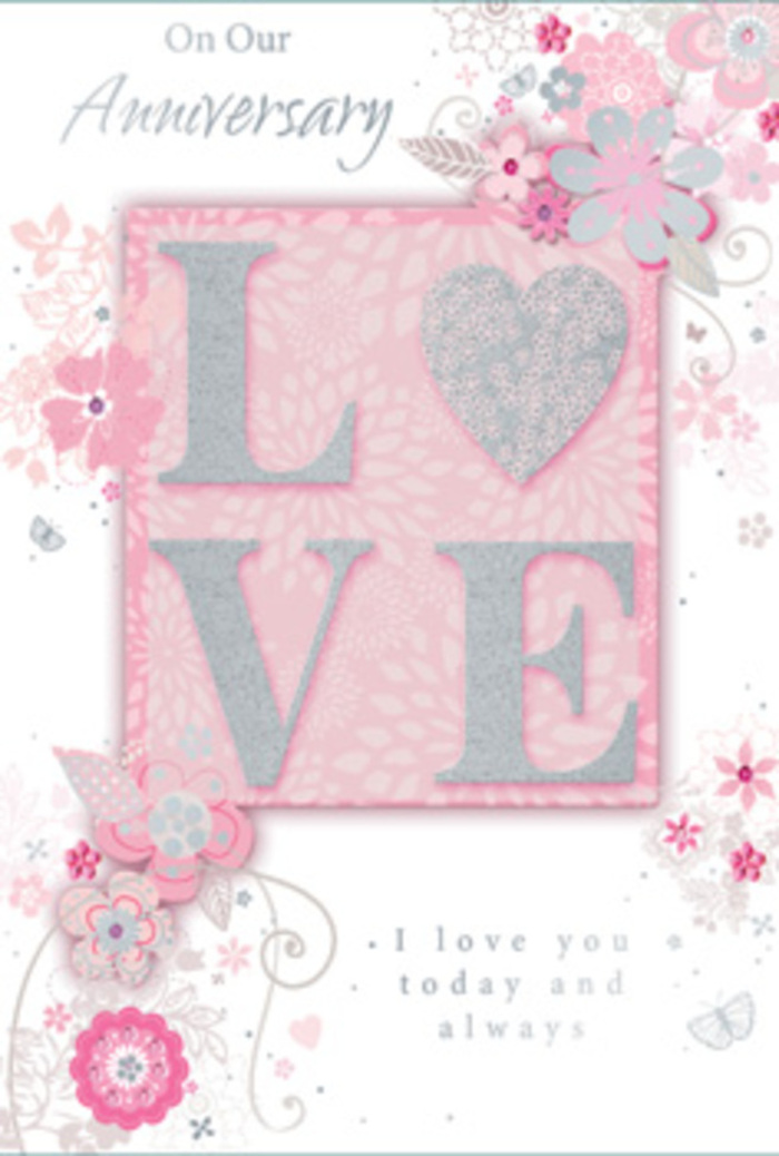 This anniversary card is portrayed in calm, even lighting, allowing every delicate detail to stand out with the same clarity as a carefully arranged bouquet in a Tring shop window. At its heart, the word LOVE appears in large, raised letters, dusted with a frosted glitter that shimmers gently rather than sparkling loudly. The texture seems velvety beneath the fingertips, inviting touch in the same way that satin ribbon on a hand-tied bouquet does. Each letter is framed with soft silver accents, and the central panel that holds the word is shaded in a tender blush pink, fading at the edges to a milkier tone, like petals layered in a pastel rose. Surrounding this central motif, graceful sprays of stylised flowers and trailing leaves stretch outwards, curling along the card's edges as if embracing the message. The florals are rendered in airy linework, their soft pinks, whites, lilacs, and muted greys overlapping with subtle shading and hints of silver foil that catch the light in small flashes, reminiscent of dew on blossoms during an early walk through Tring Park. Among the blooms, faint swirls, filigree curls, and nearly hidden butterflies offer little surprises, inviting a lingering gaze. The sentiment, expressing enduring love and ongoing commitment, is written in a refined script that feels gentle and sincere, as though penned by hand for someone dearly cherished. Overall, the card gives the impression of a paper bouquet-romantic, tender, and quietly celebratory-perfect for marking an anniversary shared at home in Tring or over dinner just off the High Street.